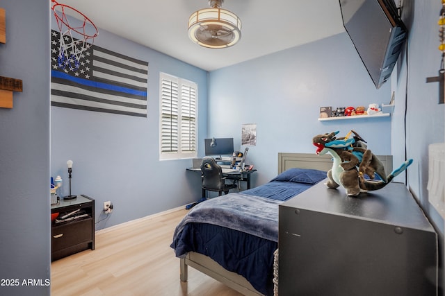 3828 E Liberty Ln, Gilbert, AZ 85296 - bedroom featuring wood finished floors, baseboards, and an office area