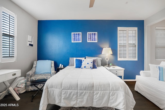 3828 E Liberty Ln, Gilbert, AZ 85296 - bedroom with a ceiling fan, wood finished floors, an accent wall, and baseboards