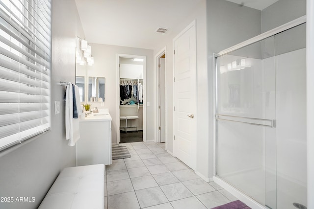 3828 E Liberty Ln, Gilbert, AZ 85296 - bathroom with vanity, a shower stall, a spacious closet, and tile patterned flooring