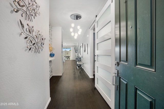 3828 E Liberty Ln, Gilbert, AZ 85296 - foyer entrance featuring a chandelier, dark wood-type flooring, and baseboards