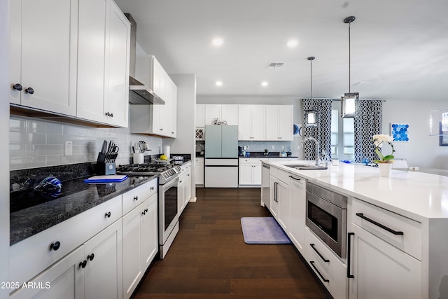 3828 E Liberty Ln, Gilbert, AZ 85296 - kitchen with appliances with stainless steel finishes, a sink, dark wood-style flooring, tasteful backsplash, and white cabinets
