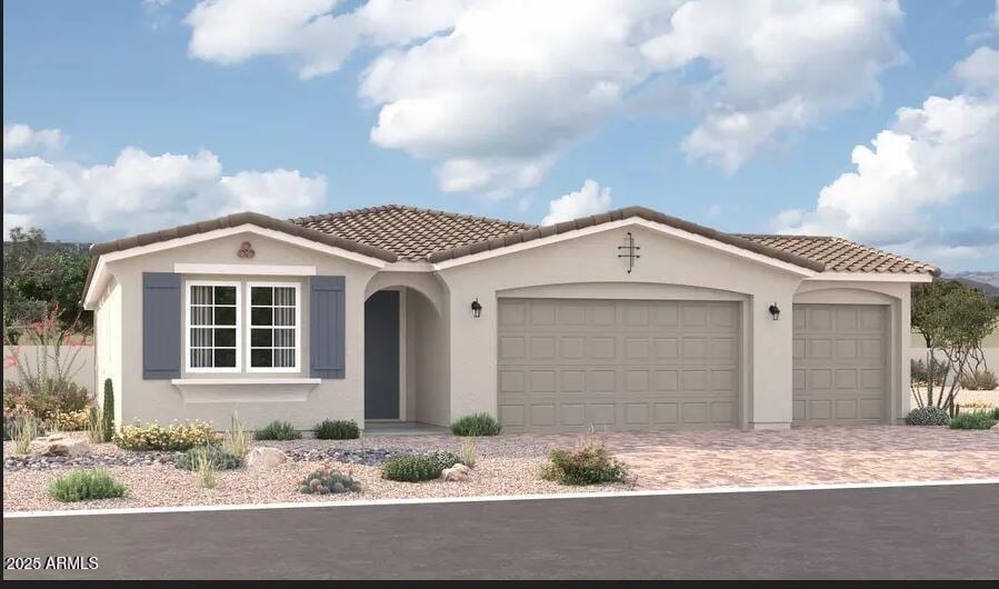 mediterranean / spanish-style house featuring driveway, an attached garage, a tiled roof, and stucco siding