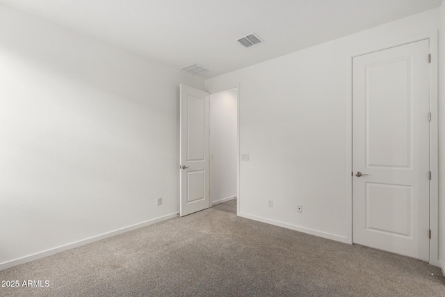unfurnished bedroom with visible vents, baseboards, and light carpet