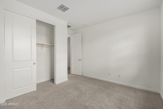 unfurnished bedroom featuring a closet, baseboards, visible vents, and light colored carpet