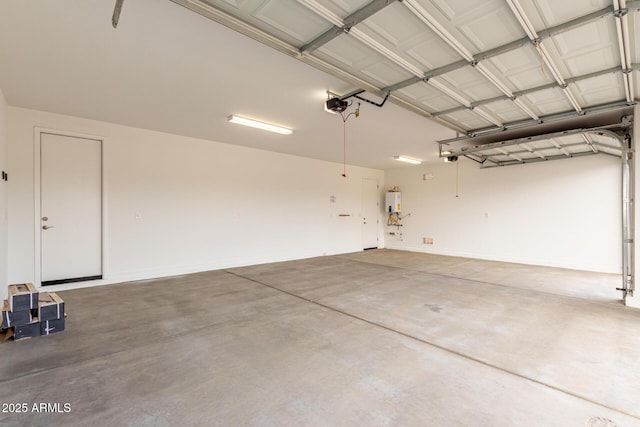 garage featuring tankless water heater and a garage door opener