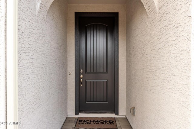 property entrance featuring stucco siding