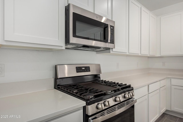 kitchen with appliances with stainless steel finishes and white cabinetry
