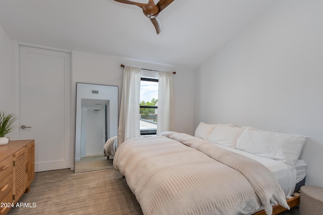 bedroom featuring visible vents, light carpet, a ceiling fan, and vaulted ceiling