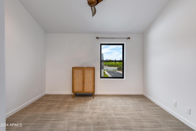 empty room featuring baseboards and carpet floors