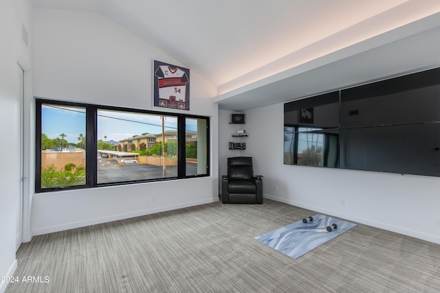 unfurnished living room featuring high vaulted ceiling, baseboards, and carpet