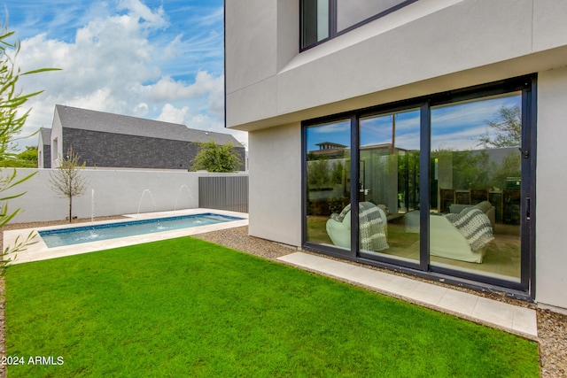 pool with a lawn and a fenced backyard