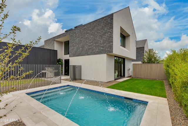 view of swimming pool featuring a patio, a fenced backyard, and a lawn