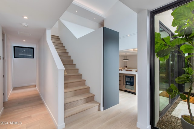 stairs with recessed lighting and wood finished floors