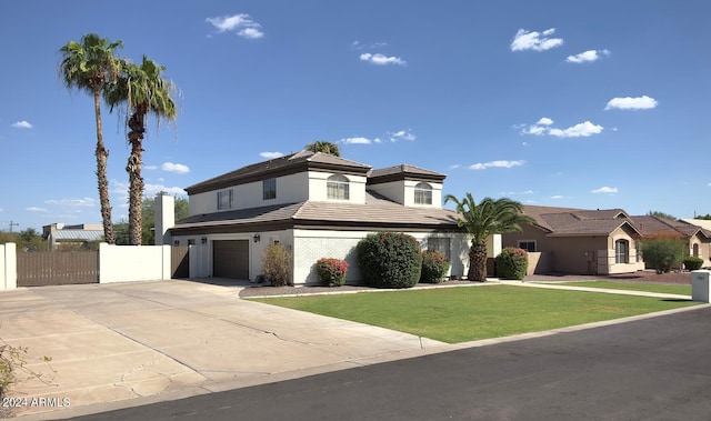 view of front of property featuring a front yard and a garage