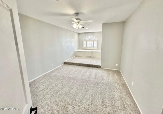 empty room featuring carpet flooring and ceiling fan