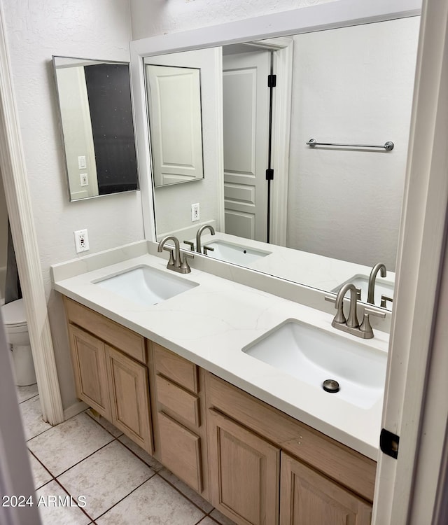 bathroom with vanity, toilet, and tile patterned flooring