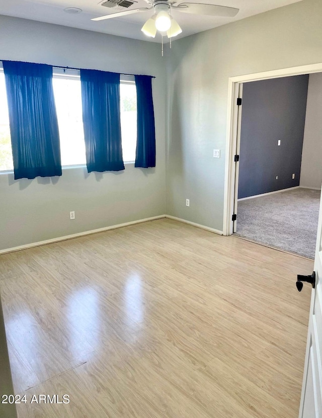 spare room with ceiling fan and light hardwood / wood-style flooring