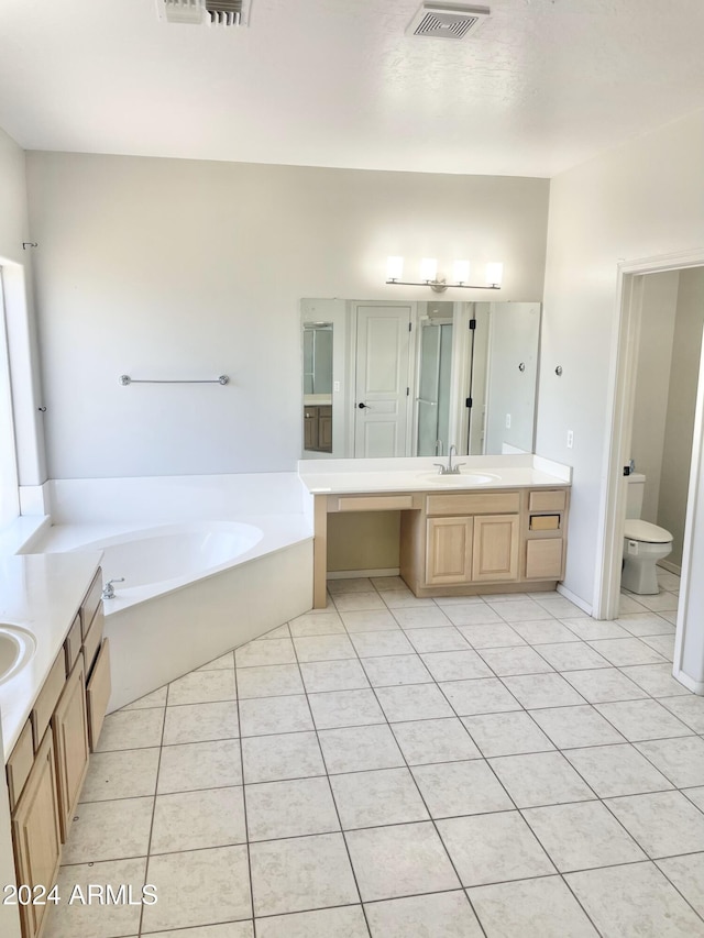 bathroom featuring a bathtub, toilet, tile patterned floors, and vanity