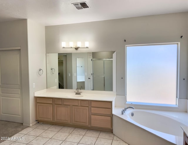 bathroom featuring vanity, shower with separate bathtub, and tile patterned flooring