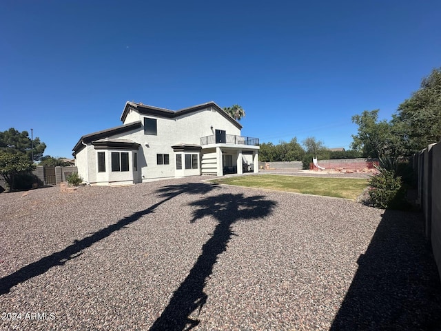 rear view of property with a yard