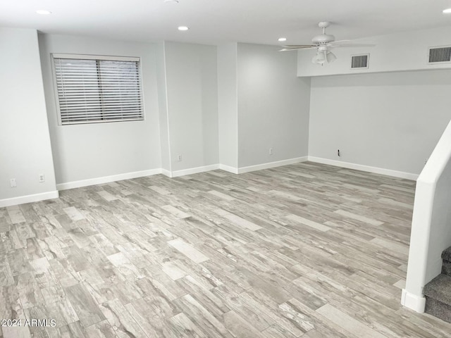 spare room with light wood-type flooring and ceiling fan