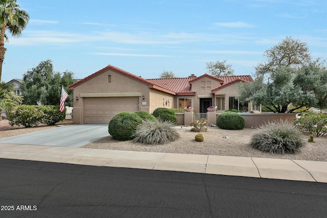 mediterranean / spanish-style home featuring concrete driveway, a tile roof, an attached garage, and stucco siding