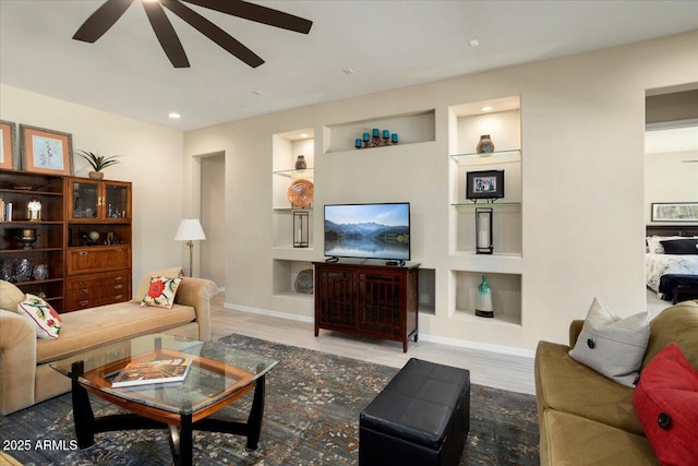 living room with hardwood / wood-style flooring and built in features