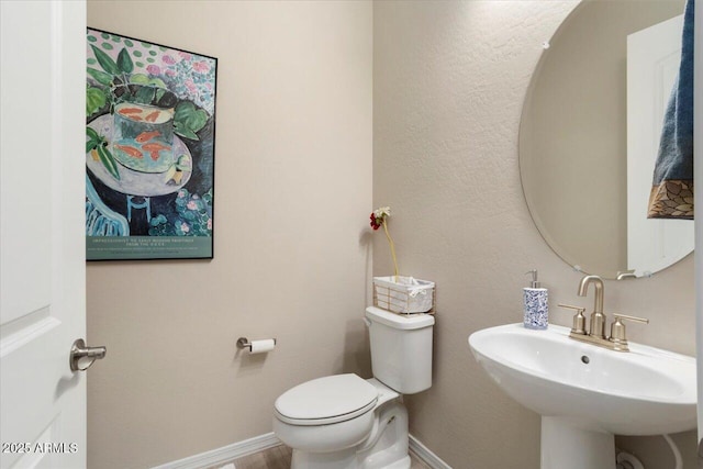 bathroom featuring sink and toilet