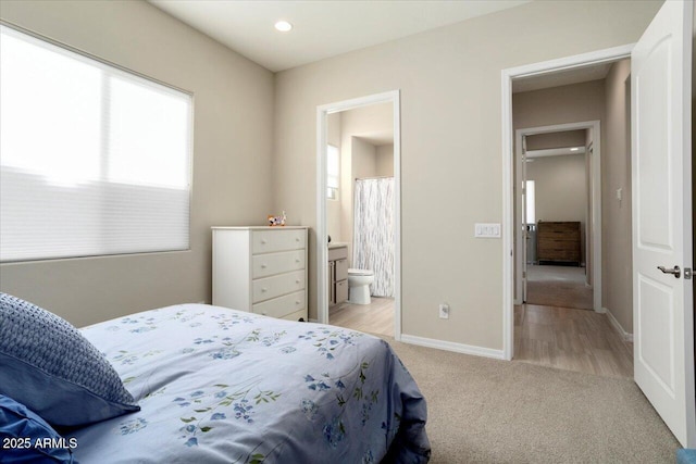 carpeted bedroom featuring connected bathroom