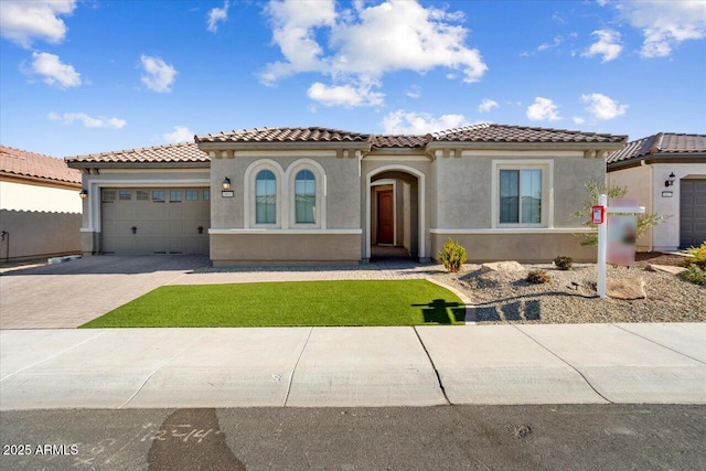 mediterranean / spanish-style home with a garage