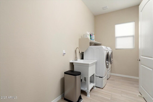 clothes washing area with washer and dryer