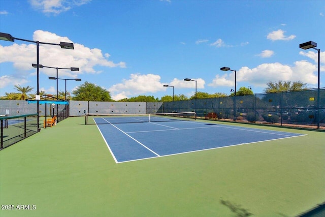 view of tennis court with basketball hoop