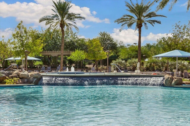 view of pool featuring pool water feature and a pergola