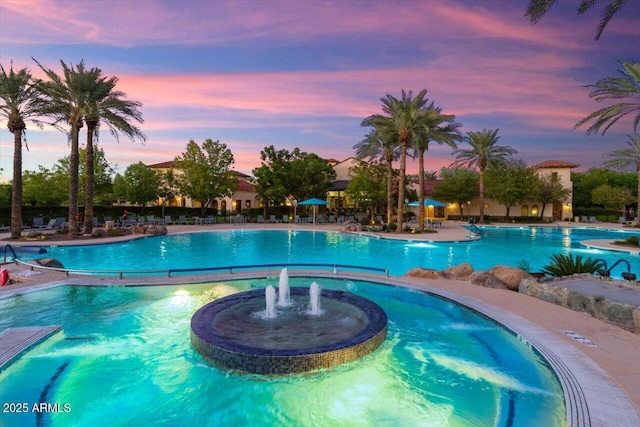 pool at dusk with pool water feature