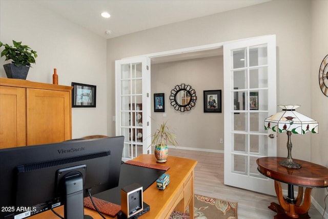 office area with french doors and light hardwood / wood-style floors