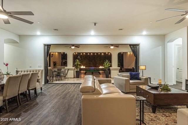 interior space featuring ceiling fan and dark hardwood / wood-style flooring