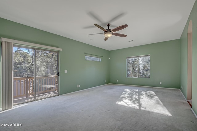 spare room featuring light colored carpet and ceiling fan