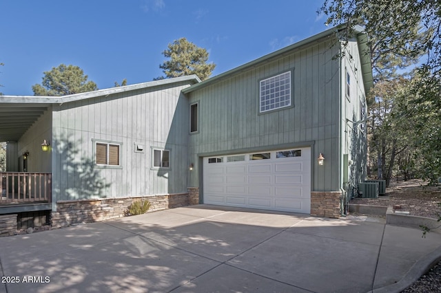 exterior space with a garage and cooling unit