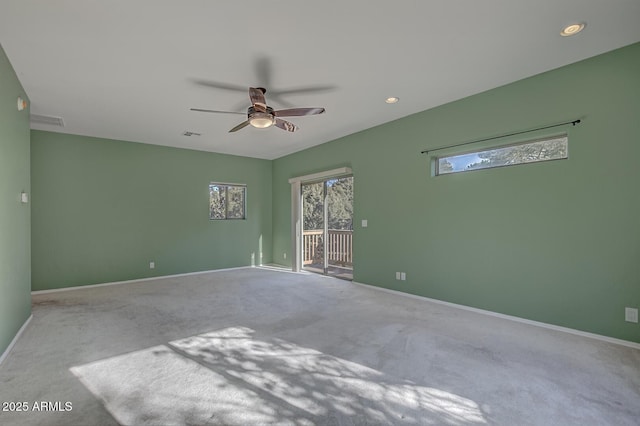 carpeted empty room featuring ceiling fan