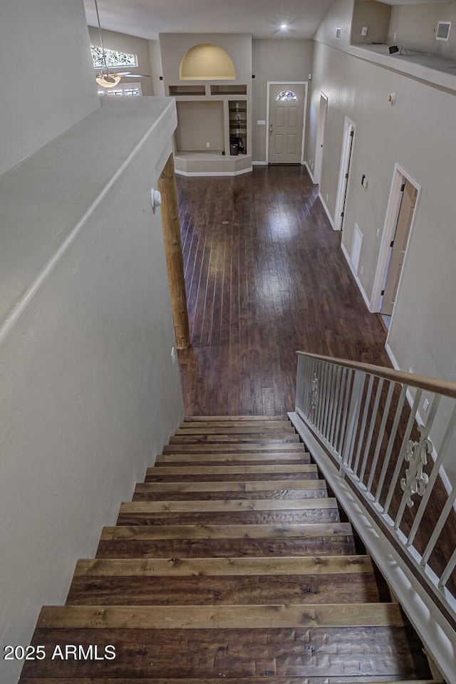 staircase with wood-type flooring