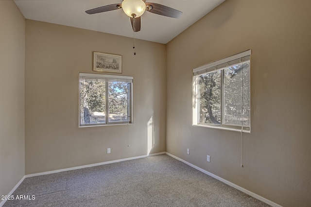 spare room with light colored carpet and ceiling fan