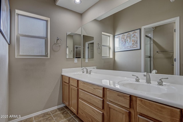 bathroom with vanity, plenty of natural light, tile patterned floors, and walk in shower