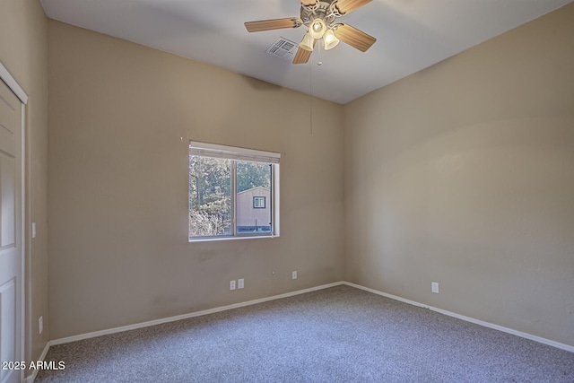 unfurnished room featuring ceiling fan and carpet