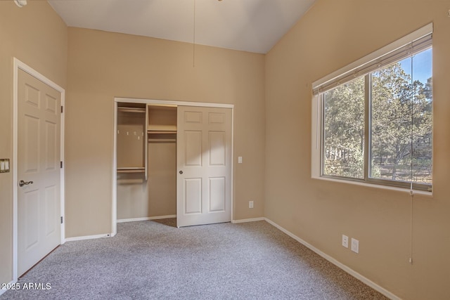 unfurnished bedroom featuring light colored carpet and a closet