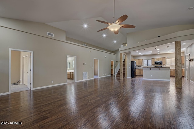 unfurnished living room with dark wood-type flooring, high vaulted ceiling, and ceiling fan