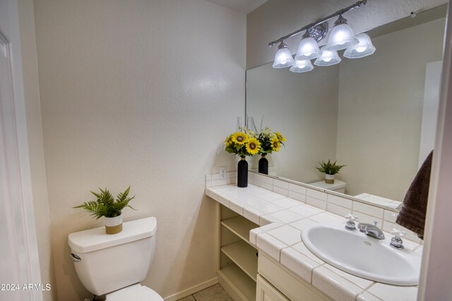 bathroom featuring toilet and vanity