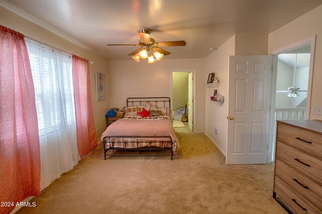 bedroom featuring ceiling fan and light colored carpet