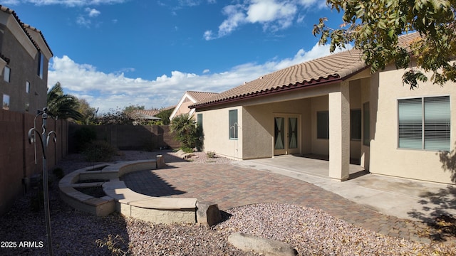 rear view of house with a patio and french doors