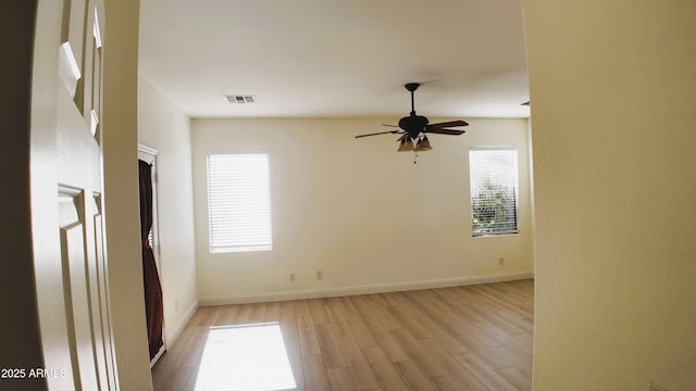 spare room with light hardwood / wood-style floors and ceiling fan