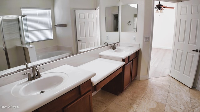 bathroom featuring ceiling fan, vanity, and independent shower and bath